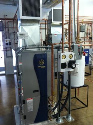Geothermal water to air unit with pump pack mounted along side