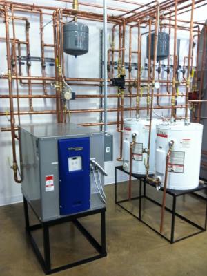 Geothermal water to air unit with 20 gallon storage tanks along side